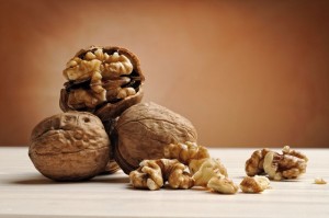group of walnuts on a table with brown background