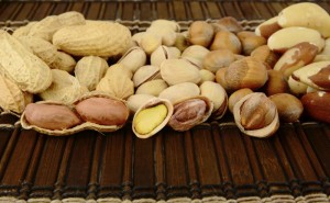 Nuts in line-peanuts,walnuts,pistachios,brasil nuts on brown mat