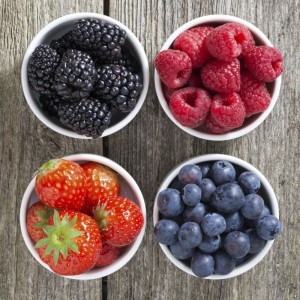 strawberries, blueberries, blackberries and raspberries in bowls