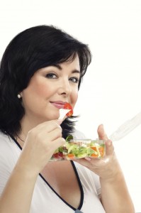 Woman eating healthy vegetable salad