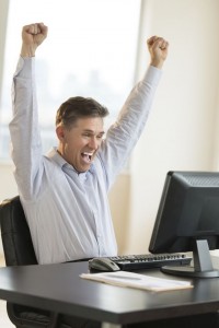 Successful Businessman Screaming While Using Computer