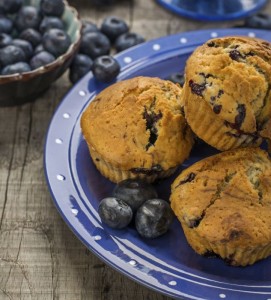 Homemade muffins with blueberries on a wooden background