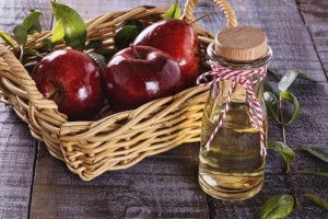 Apple cider vinegar over rustic wooden background