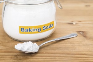 Jar and spoonful of baking soda for multiple holistic usages