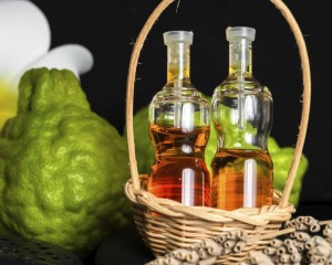Aromatic spa concept of bottles essential oil in basket, flower,